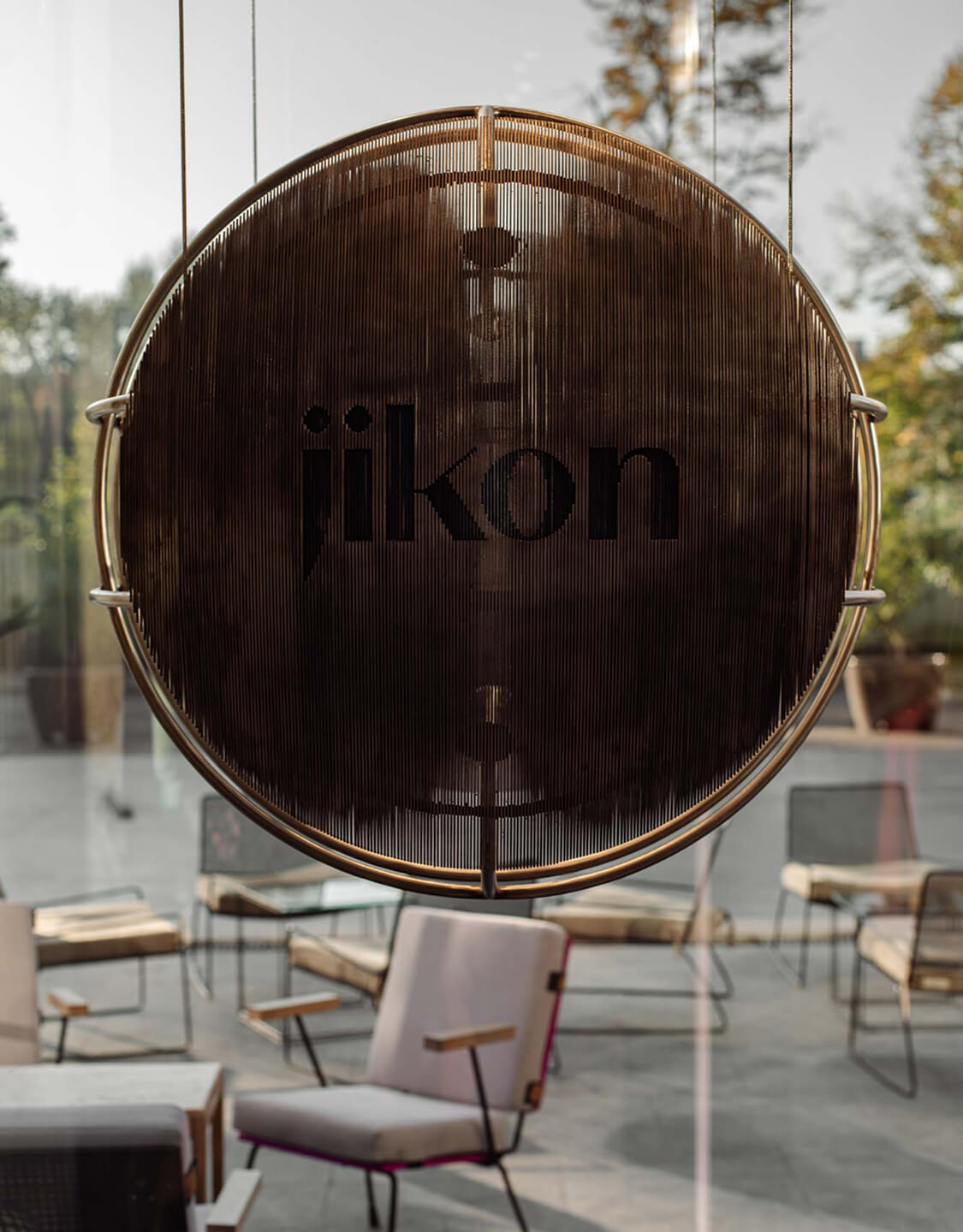 Jikon branded paper shopping bag with handles on a surface